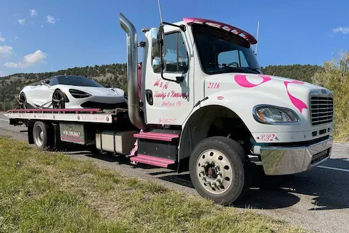 Towing a white McClaren of the highway in Montrose Colorado by M&H Towing and Recovery